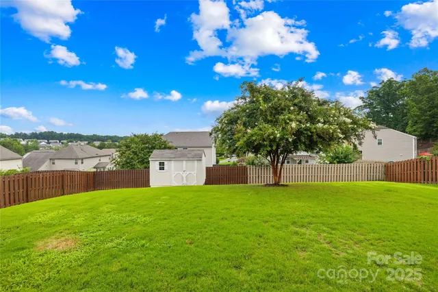 a view of a yard with a house in the background