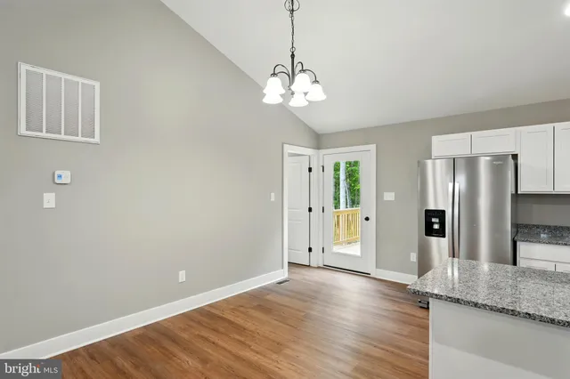 a view of a kitchen with a sink and refrigerator