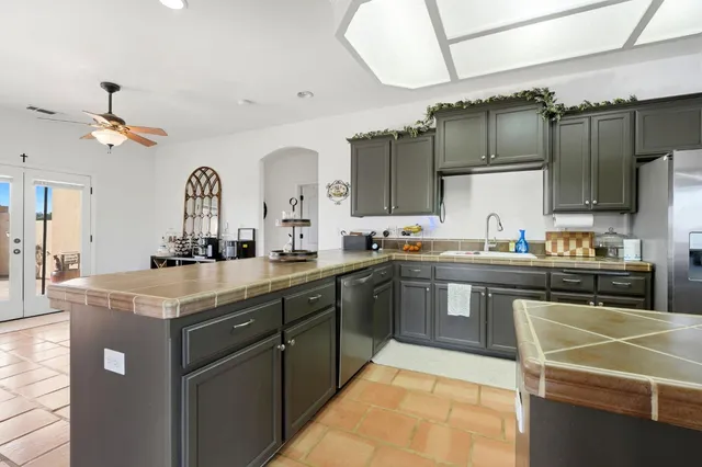 a kitchen with stainless steel appliances granite countertop a stove and a sink