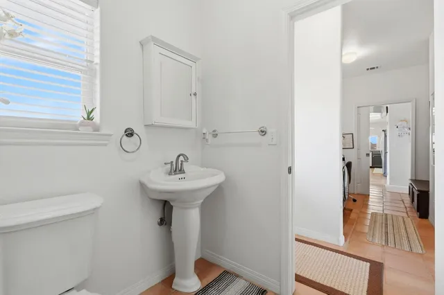 a bedroom with furniture and a flat screen tv
