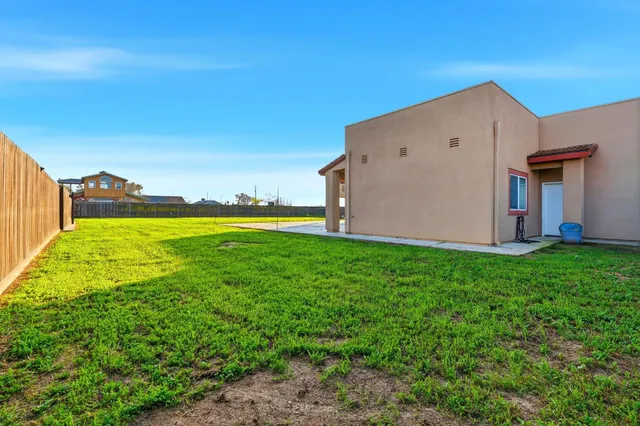 an aerial view of a house with a garden and lake view