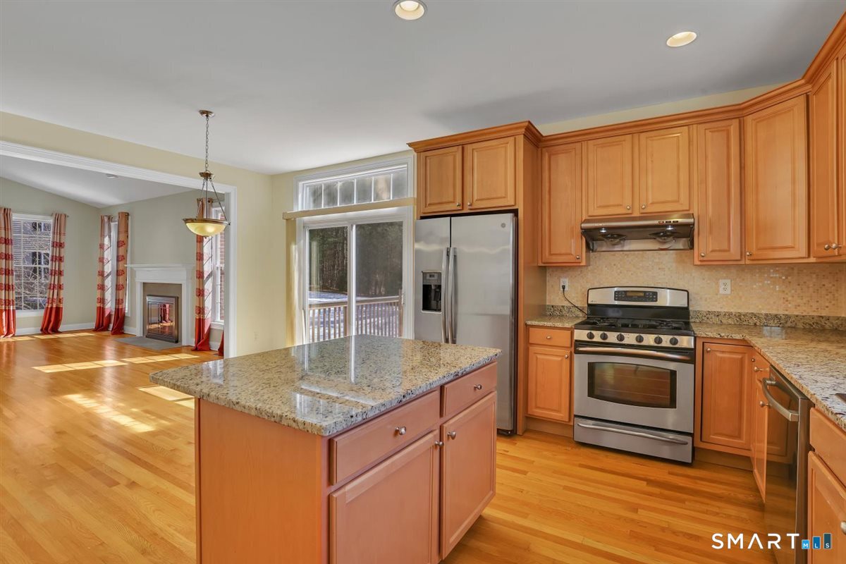 25 Fenwick Drive Avon, CT 06001 - Photo 10 of 40 a kitchen with stainless steel appliances granite countertop a stove a sink dishwasher and a refrigerator