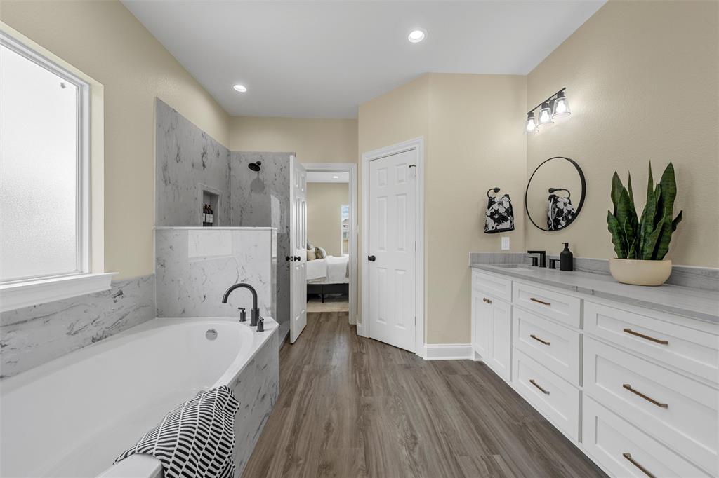 929 Northern Dancer Drive Hewitt, TX 76643 - Photo 17 of 36 a spacious bathroom with a tub double sink and a mirror