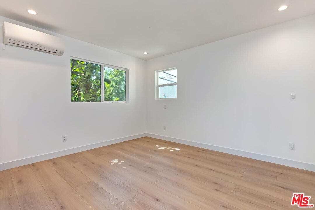3431 Edgehill Drive Los Angeles, CA 90018 - Photo 14 of 17 an empty room with wooden floor and window