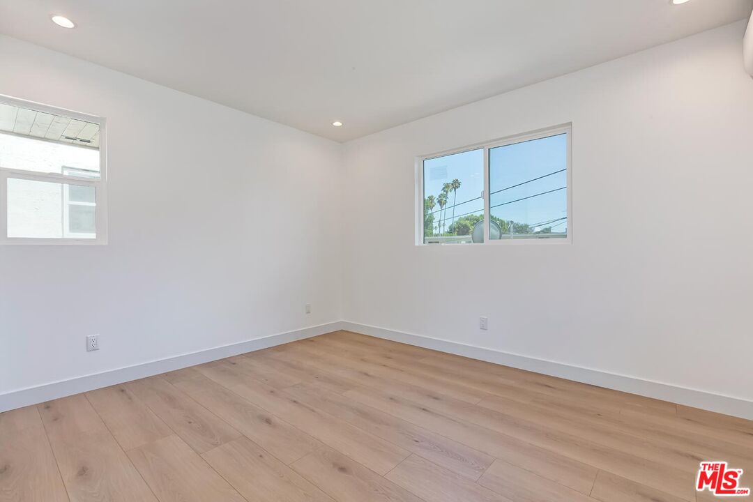 3431 Edgehill Drive Los Angeles, CA 90018 - Photo 16 of 17 wooden floor in an empty room with a window