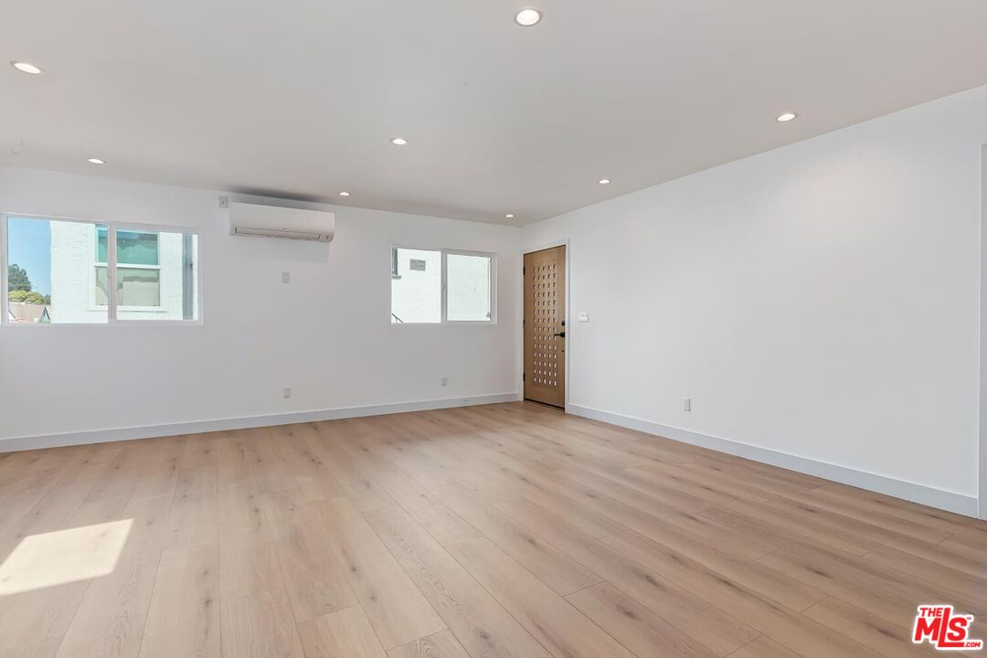 3431 Edgehill Drive Los Angeles, CA 90018 - Photo 17 of 17 an empty room with wooden floor and windows
