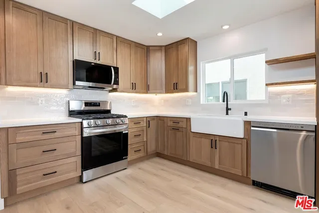 a kitchen with a sink stove and microwave