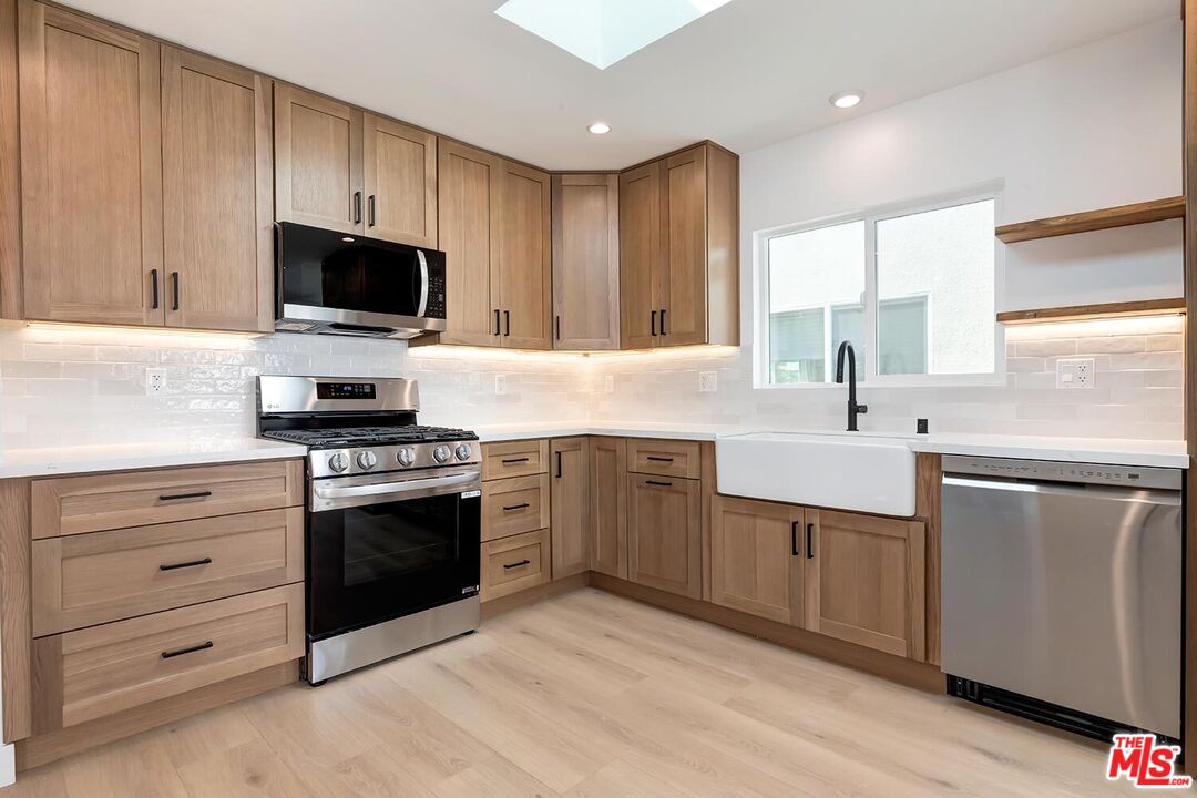 3431 Edgehill Drive Los Angeles, CA 90018 - Photo 3 of 17 a kitchen with a sink stove and microwave