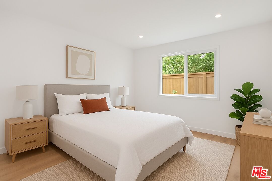 3431 Edgehill Drive Los Angeles, CA 90018 - Photo 5 of 17 a large bed sitting in a bedroom next to a window