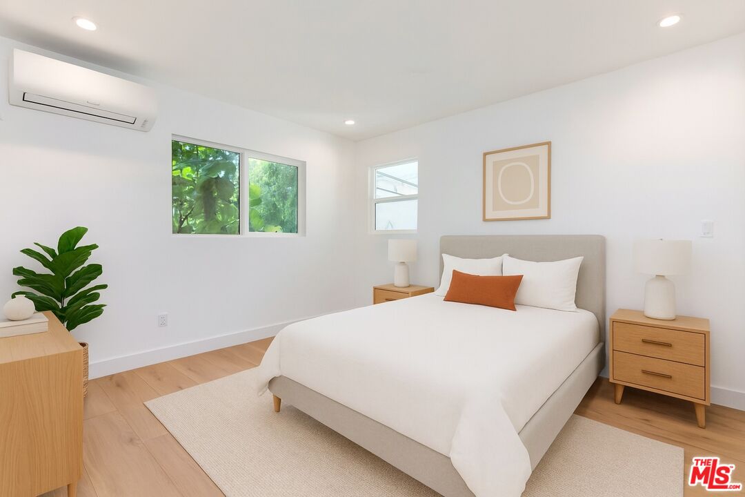 3431 Edgehill Drive Los Angeles, CA 90018 - Photo 7 of 17 a bedroom with a bed and a potted plant