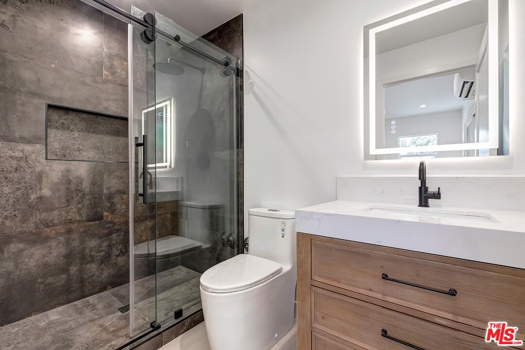 3431 Edgehill Drive Los Angeles, CA 90018 - Photo 8 of 17 a bathroom with a sink a toilet and shower