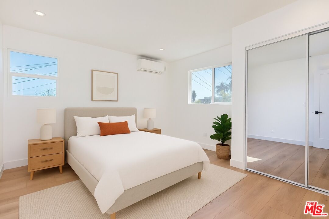 3431 Edgehill Drive Los Angeles, CA 90018 - Photo 9 of 17 a bedroom with a bed and a potted plant