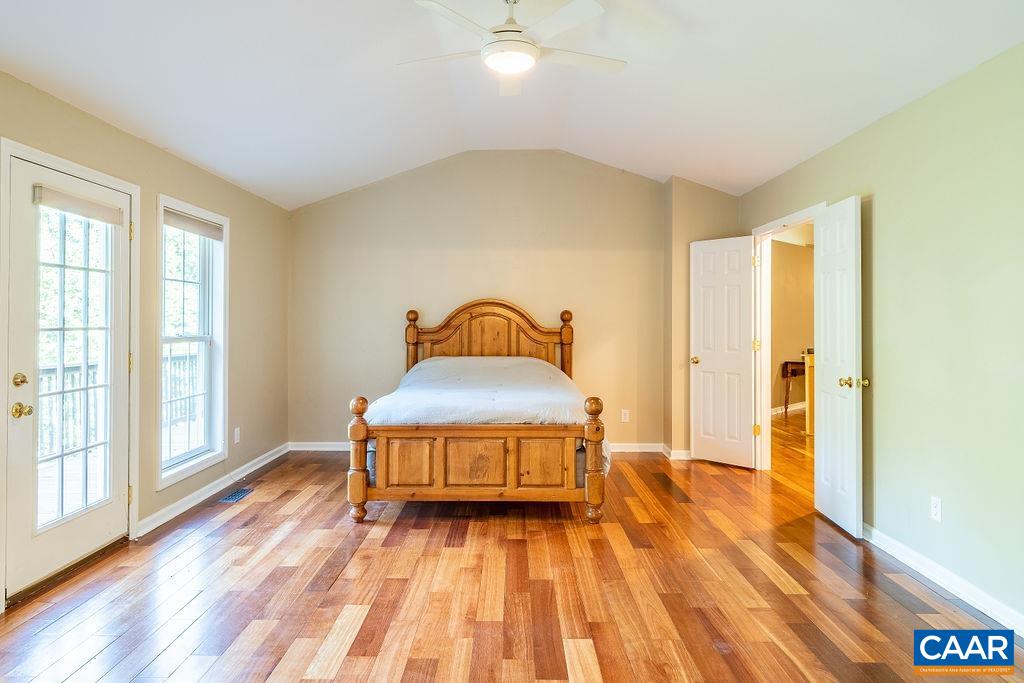 475 David Road Charlottesville, VA 22902 - Photo 15 of 38 a spacious bedroom with a bed and wooden floor