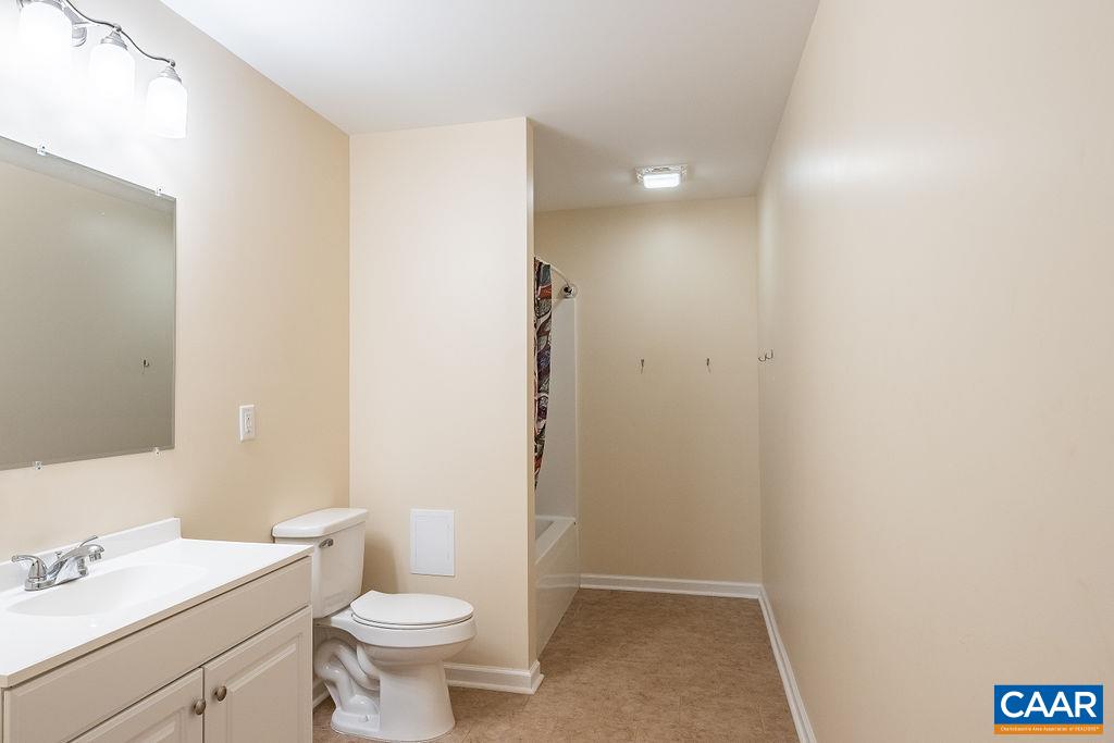 475 David Road Charlottesville, VA 22902 - Photo 29 of 38 a bathroom with a sink a toilet a mirror and vanity