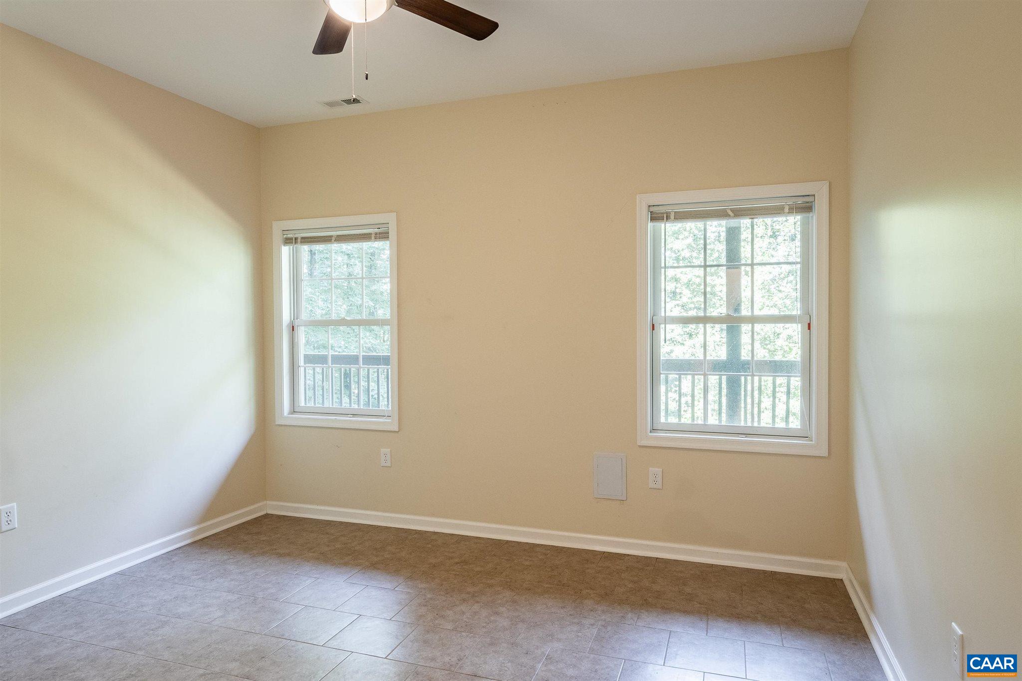 475 David Road Charlottesville, VA 22902 - Photo 30 of 38 an empty room with chandelier fan and windows