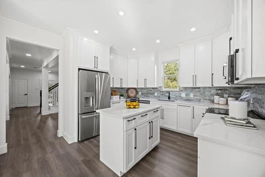 4147 Rench Road Fort Worth, TX 76135 - Photo 12 of 30 a kitchen with stainless steel appliances granite countertop a refrigerator a stove a sink and white cabinets with wooden floor