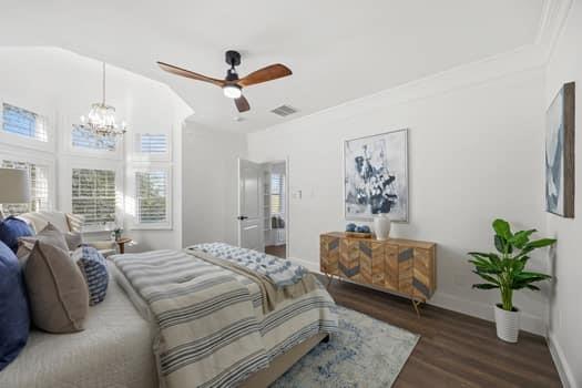 4147 Rench Road Fort Worth, TX 76135 - Photo 19 of 30 a bedroom with a large bed and a chandelier