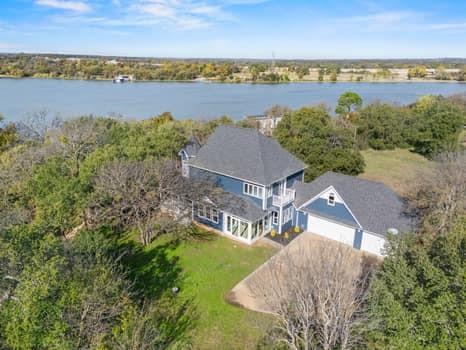 4147 Rench Road Fort Worth, TX 76135 - Photo 4 of 30 an aerial view of a house with a garden and lake view