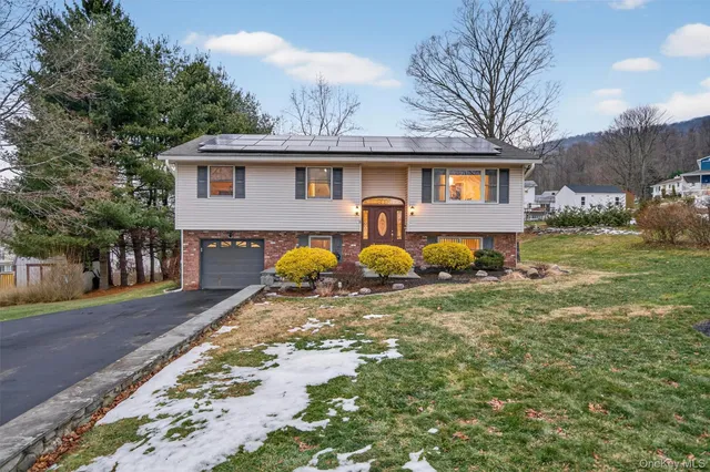 a front view of a house with garden