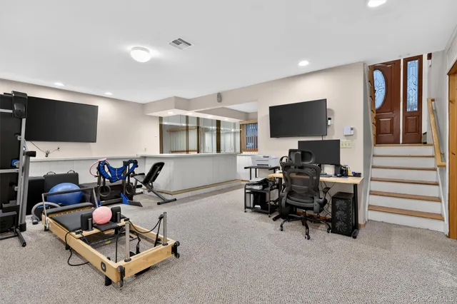 a living room with furniture a flat screen tv and a window