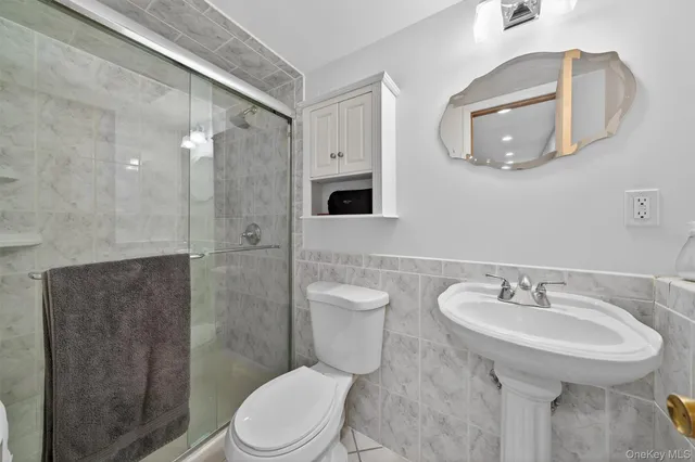 a bathroom with a toilet sink and shower