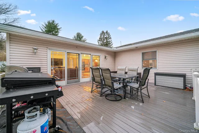 a view of a patio with table and chairs and wooden floor