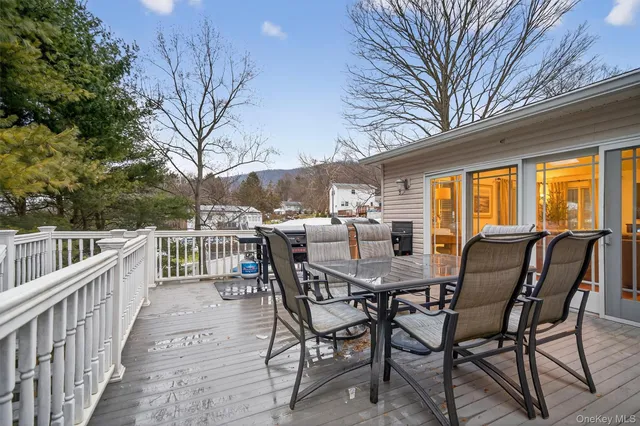 a view of a chairs and table in the balcony