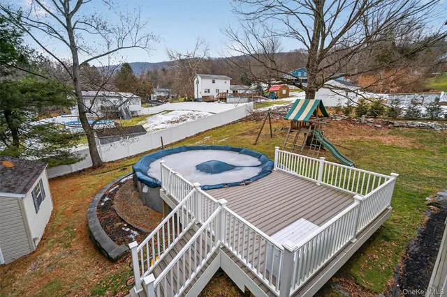 a view of a roof deck with couches and wooden floor