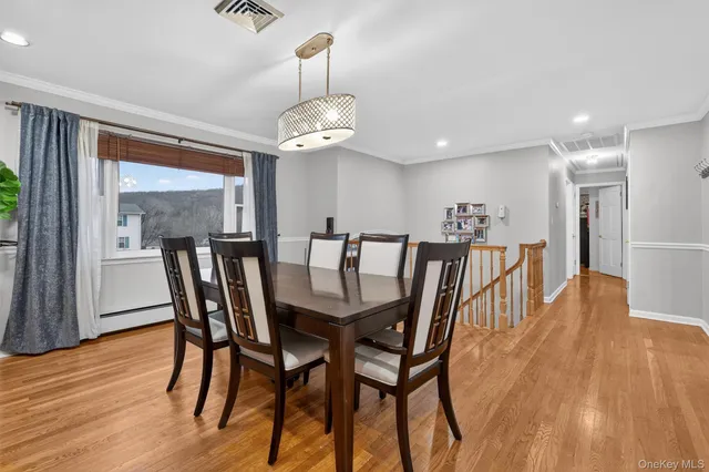 a view of a dining room with furniture wooden floor and chandelier