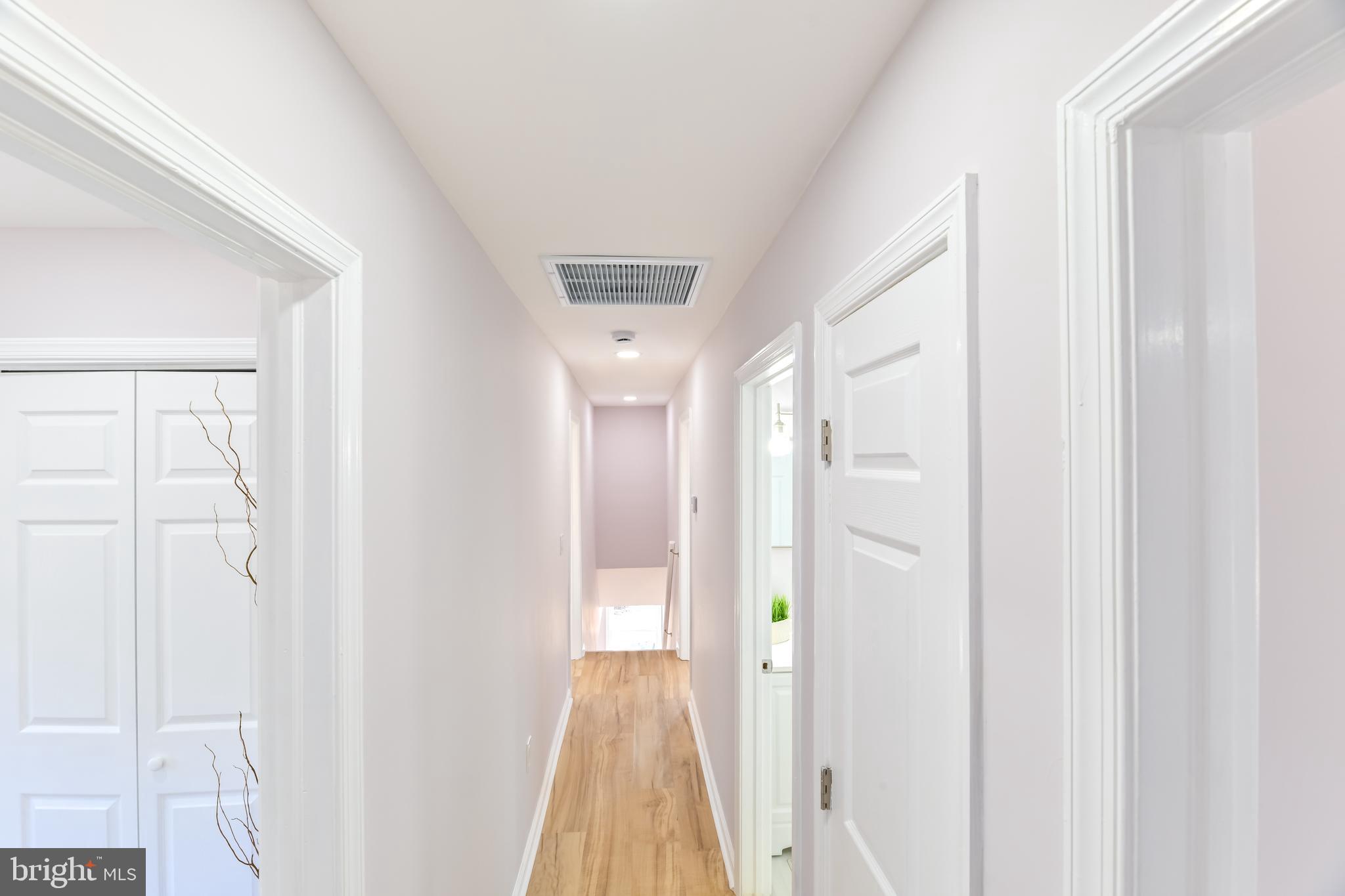 6716 Johnnycake Road Catonsville, MD 21228 - Photo 13 of 23 a view of a hallway with wooden floor and entryway