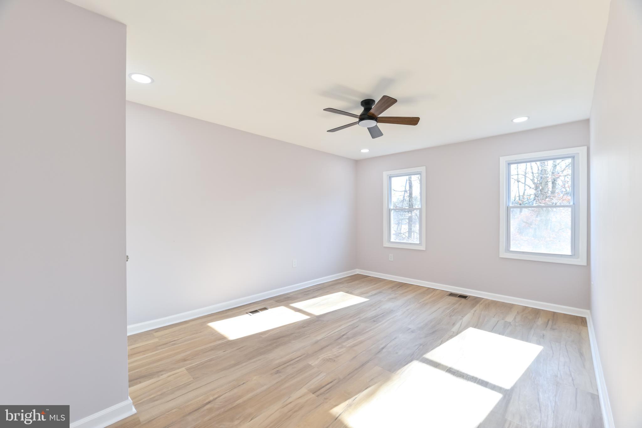 6716 Johnnycake Road Catonsville, MD 21228 - Photo 14 of 23 an empty room with wooden floor and windows