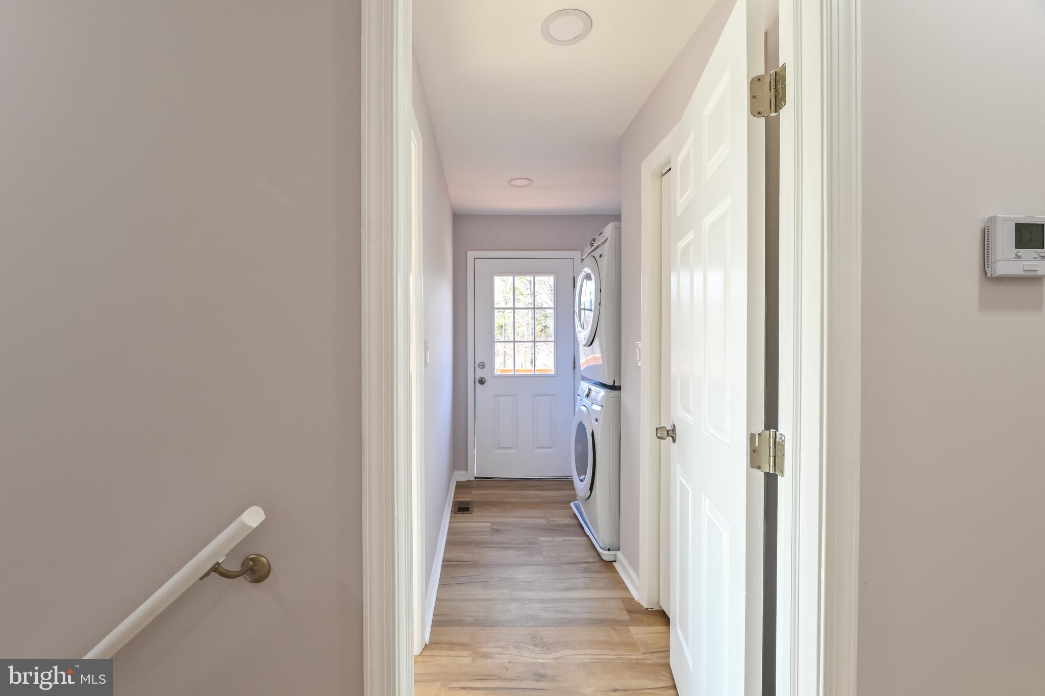 6716 Johnnycake Road Catonsville, MD 21228 - Photo 15 of 23 a view of a hallway with wooden floor and a bathroom