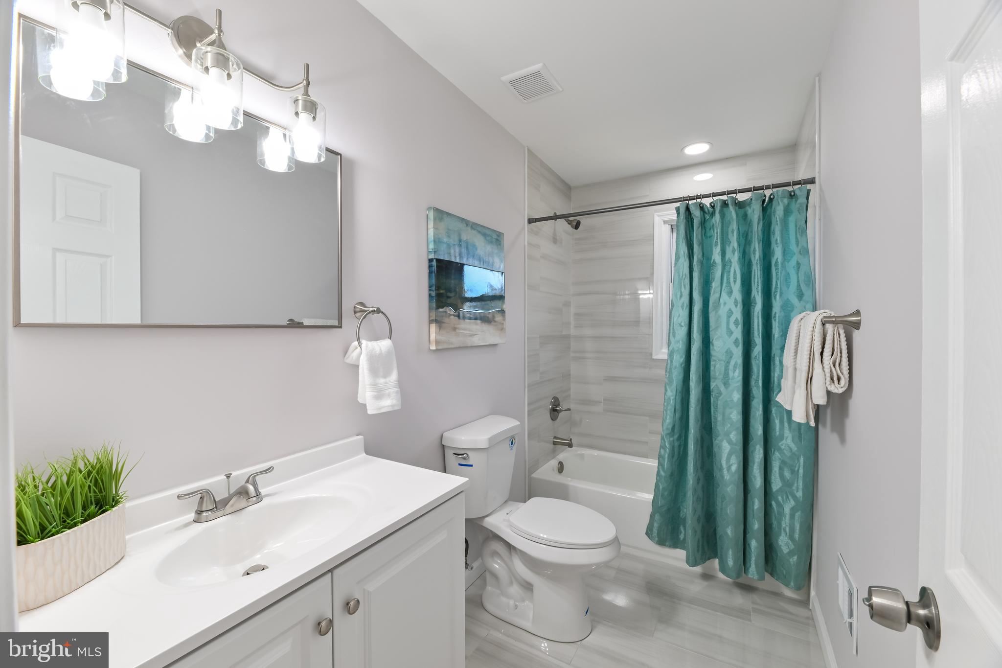 6716 Johnnycake Road Catonsville, MD 21228 - Photo 17 of 23 a bathroom with a sink a toilet and shower