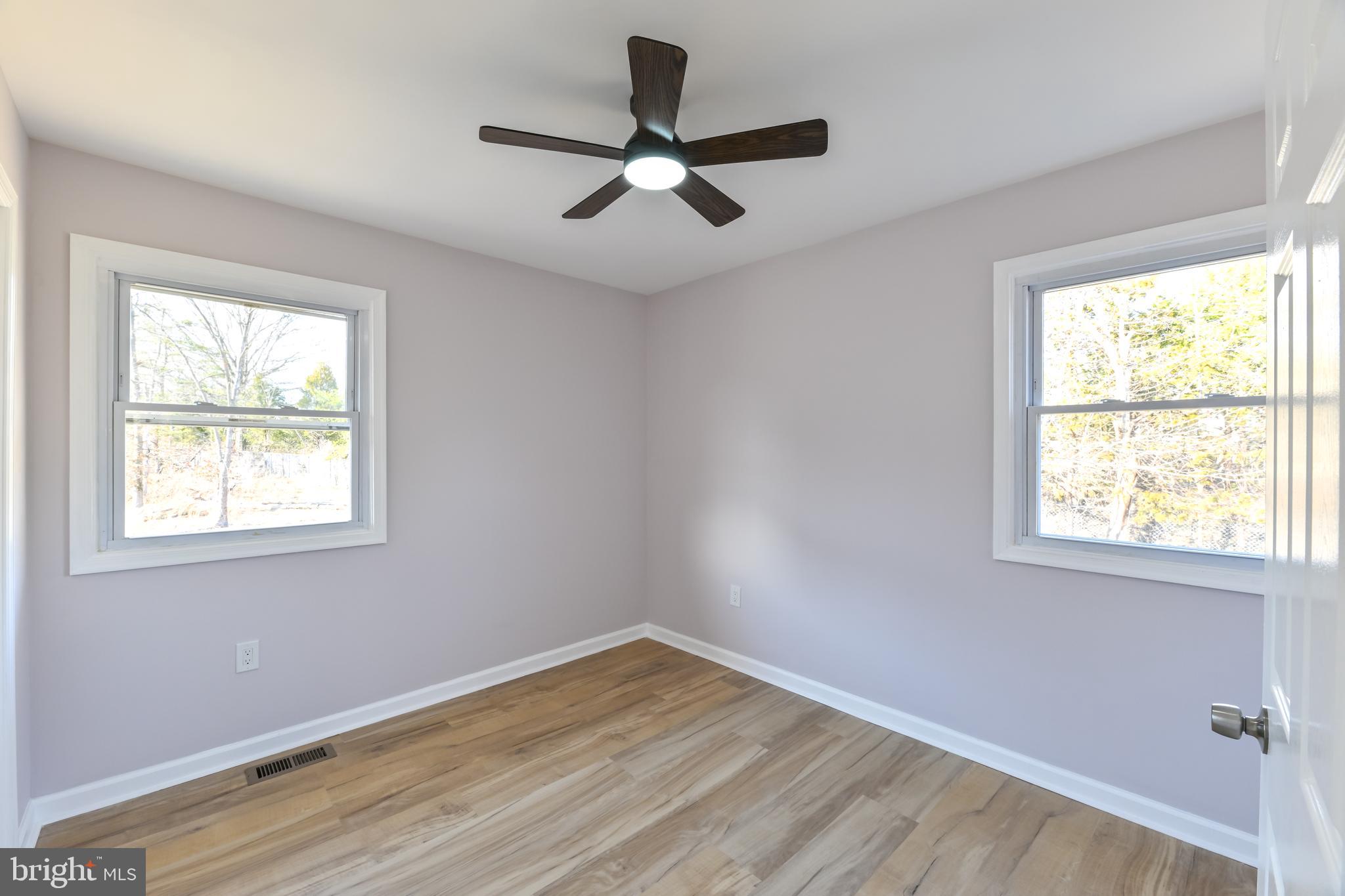 6716 Johnnycake Road Catonsville, MD 21228 - Photo 18 of 23 a view of an empty room with wooden floor and a window