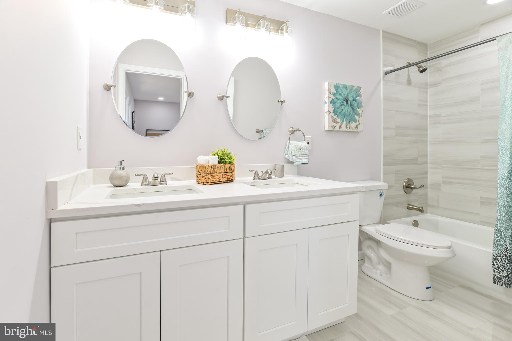 6716 Johnnycake Road Catonsville, MD 21228 - Photo 21 of 23 a bathroom with a toilet sink and mirror