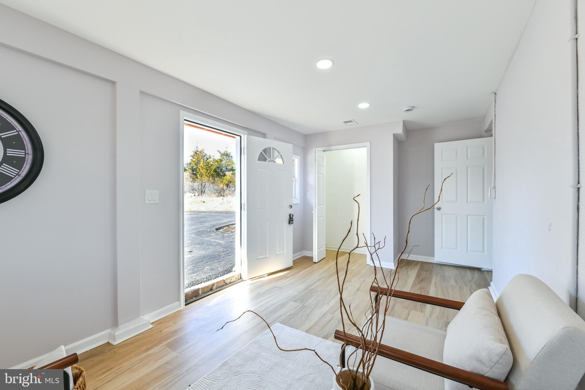 6716 Johnnycake Road Catonsville, MD 21228 - Photo 23 of 23 a view of an empty room with wooden floor and a window