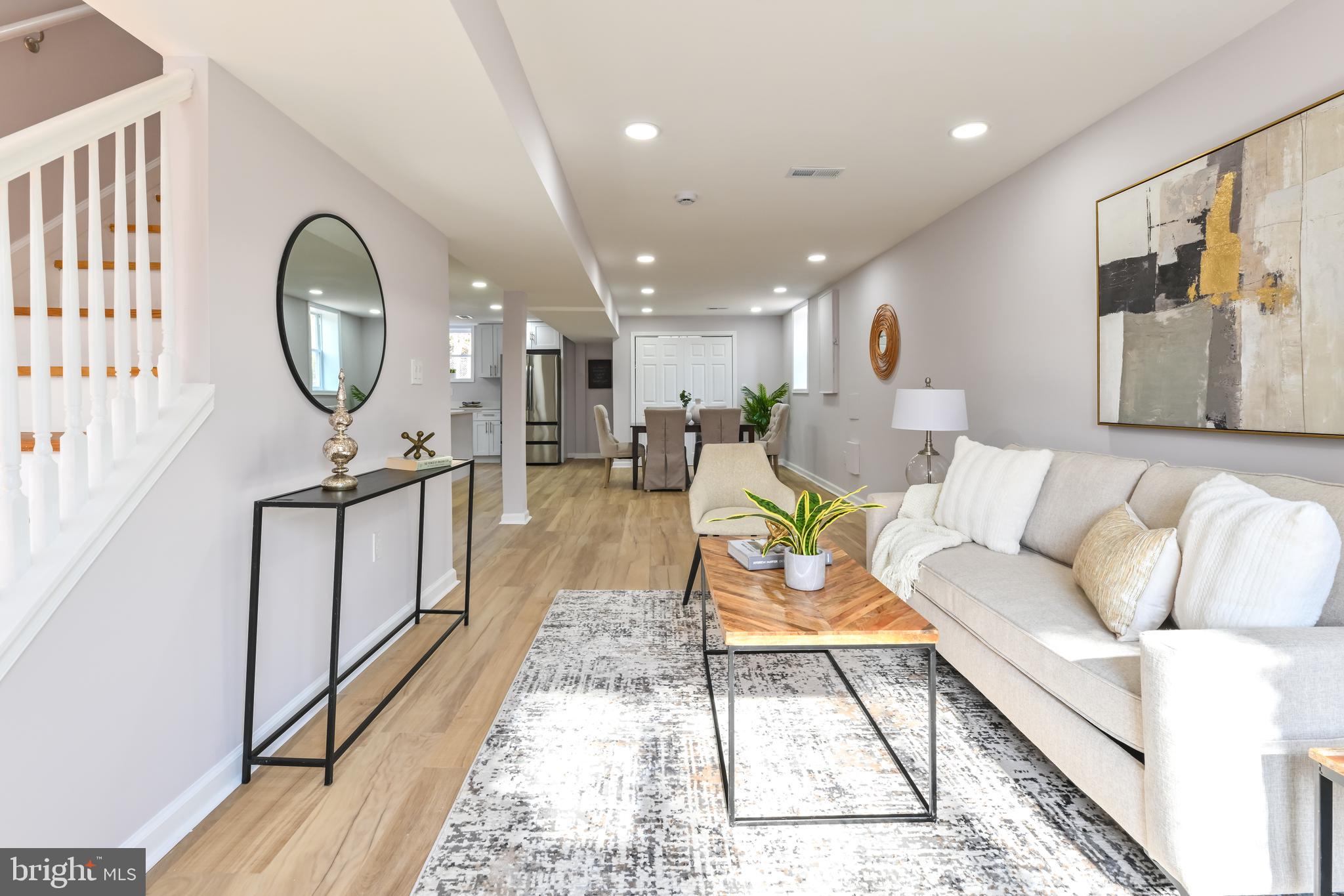 6716 Johnnycake Road Catonsville, MD 21228 - Photo 3 of 23 a living room with furniture a mirror and a table