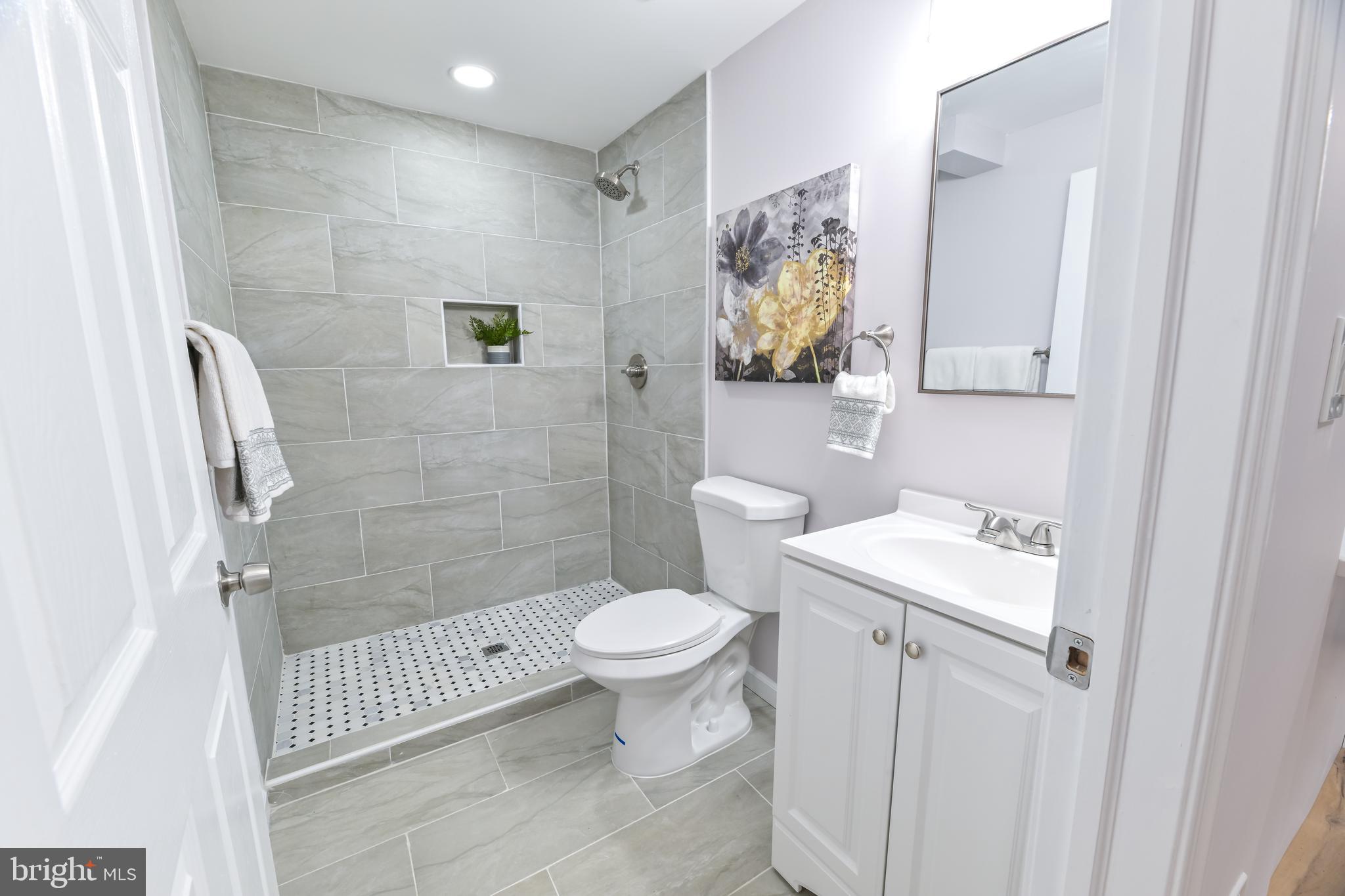 6716 Johnnycake Road Catonsville, MD 21228 - Photo 8 of 23 a bathroom with a toilet sink and shower