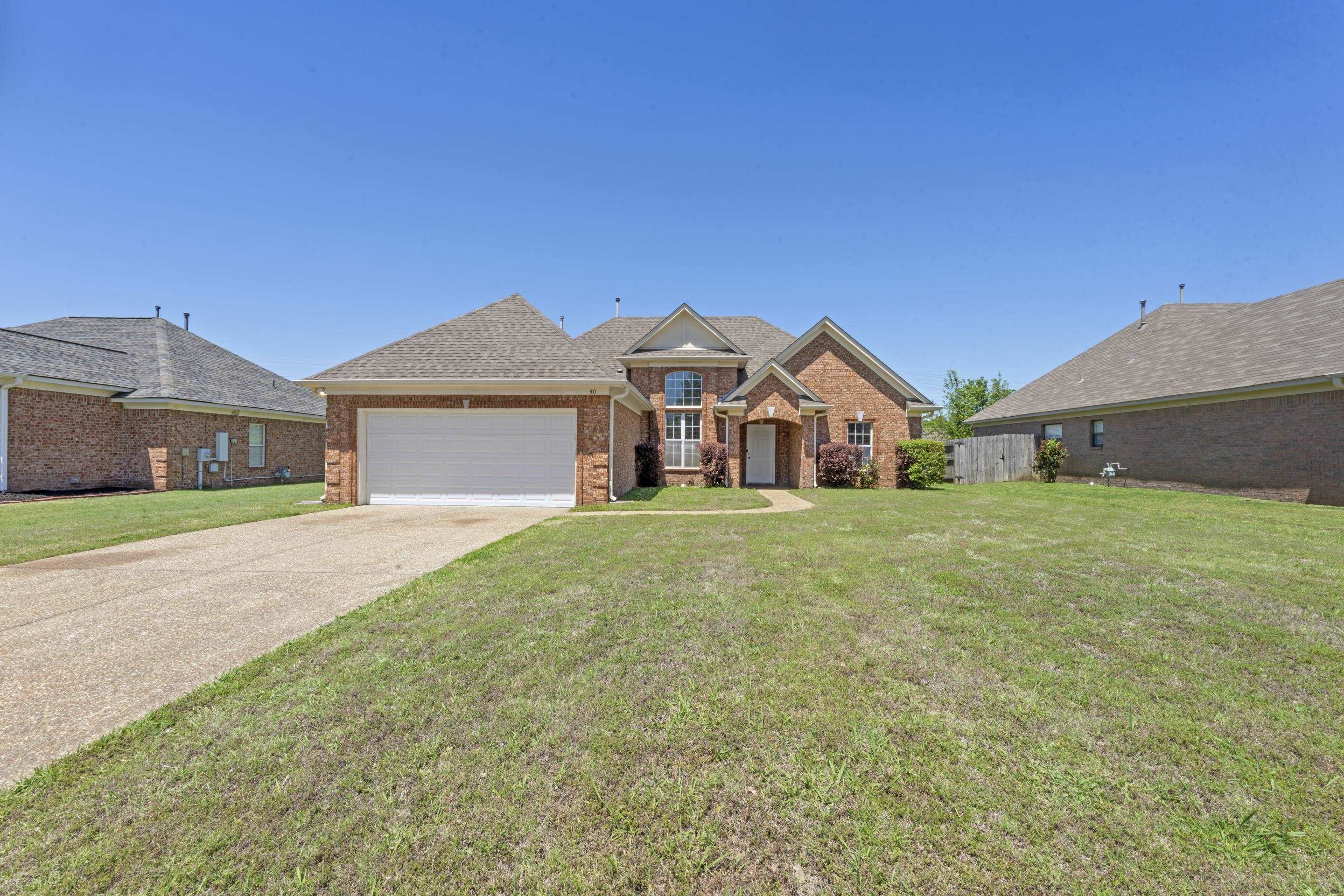 50 Abbey Road Oakland, TN 38060 - Photo 1 of 26 Brick exterior with a prominent two-car garage