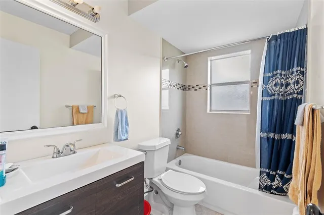a bathroom with a sink toilet tub and shower
