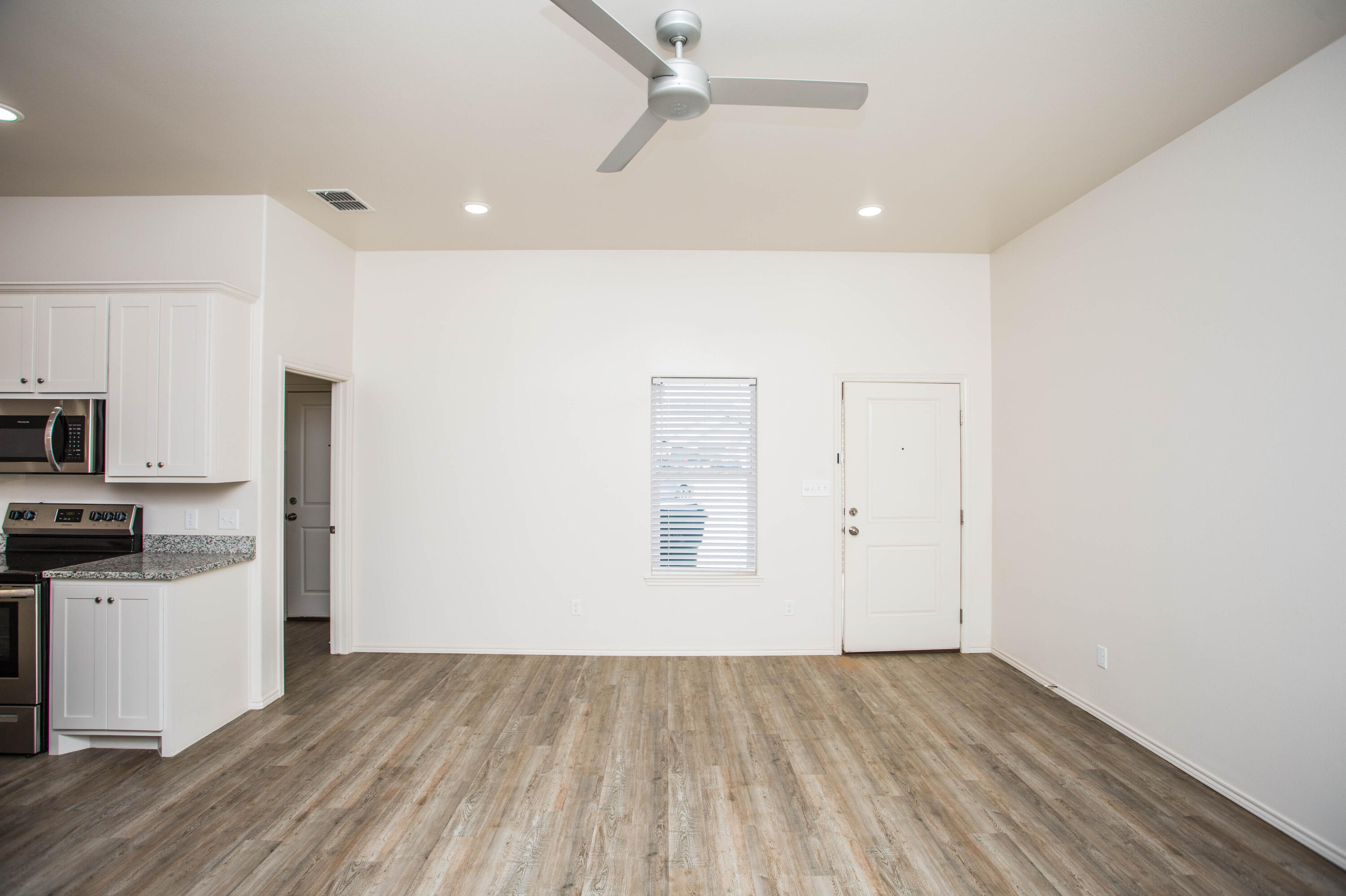 5613 Kemper Street Lubbock, TX 79416 - Photo 12 of 35 a view of a kitchen with wooden floor and electronic appliances
