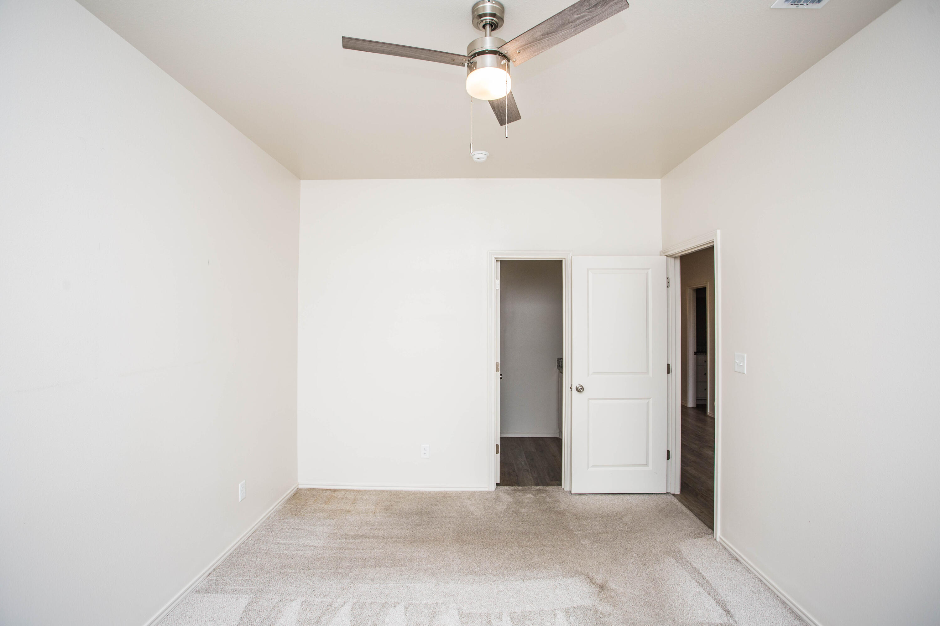 5613 Kemper Street Lubbock, TX 79416 - Photo 16 of 35 an empty room with closet and a chandelier fan