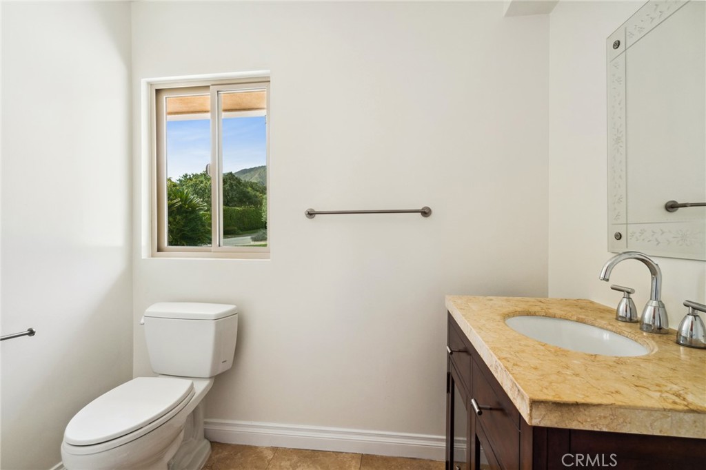 3336 Villa Mesa Road Pasadena, CA 91107 - Photo 17 of 60 a bathroom with a granite countertop sink toilet and mirror