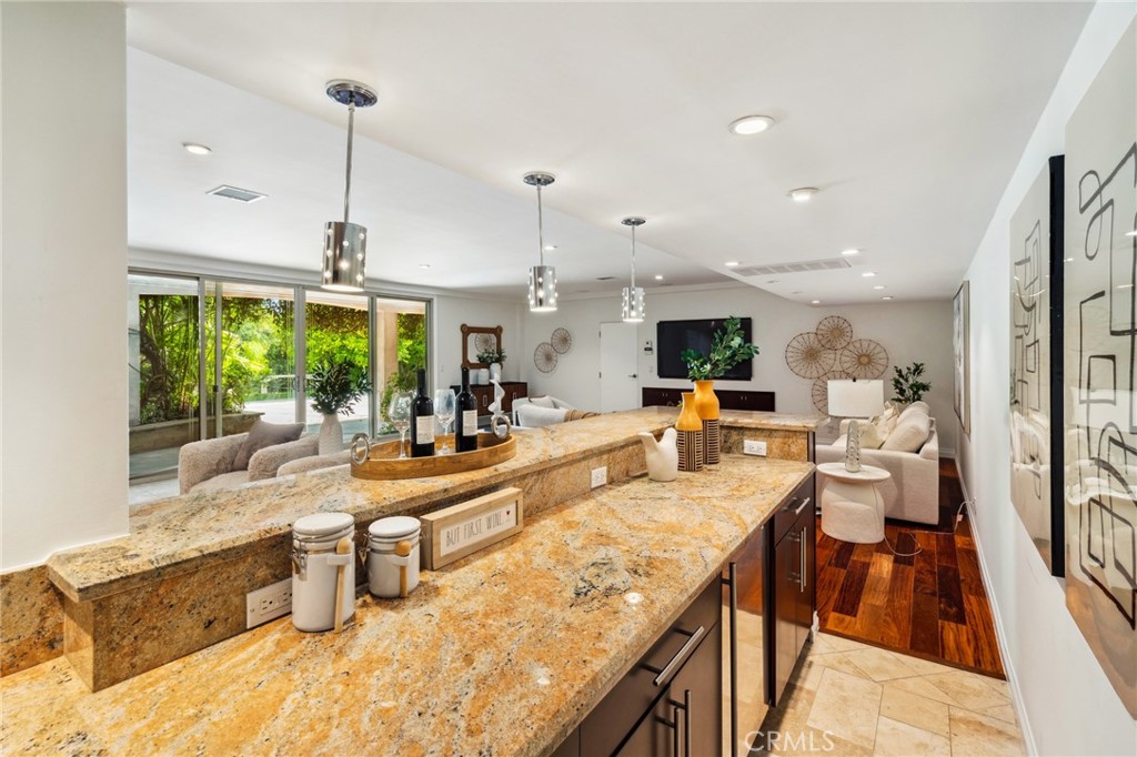 3336 Villa Mesa Road Pasadena, CA 91107 - Photo 37 of 60 a large kitchen with kitchen island a large counter top space a sink a window and stainless steel appliances