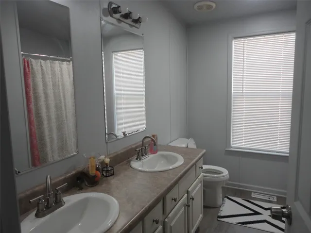a bathroom with 2 sink and a mirror