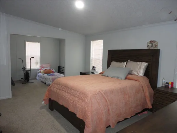 a bedroom with a bed and window