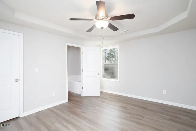a view of an empty room and wooden floor