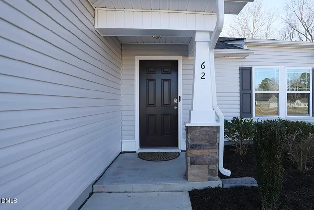 a couple of potted plants in front of door