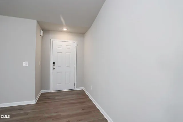a view of hallway with wooden floor