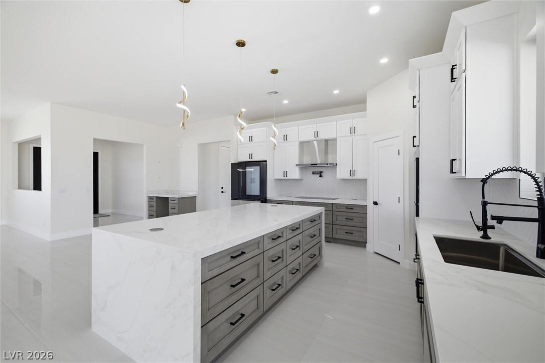 5910 East Kellogg Road Pahrump, NV 89061 - Photo 19 of 58 A pristine kitchen features a large island and ample counter space, perfect for culinary endeavors.